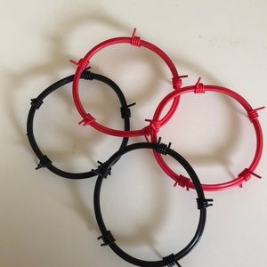 Set of 4 plastic “barbed wire” bracelets.